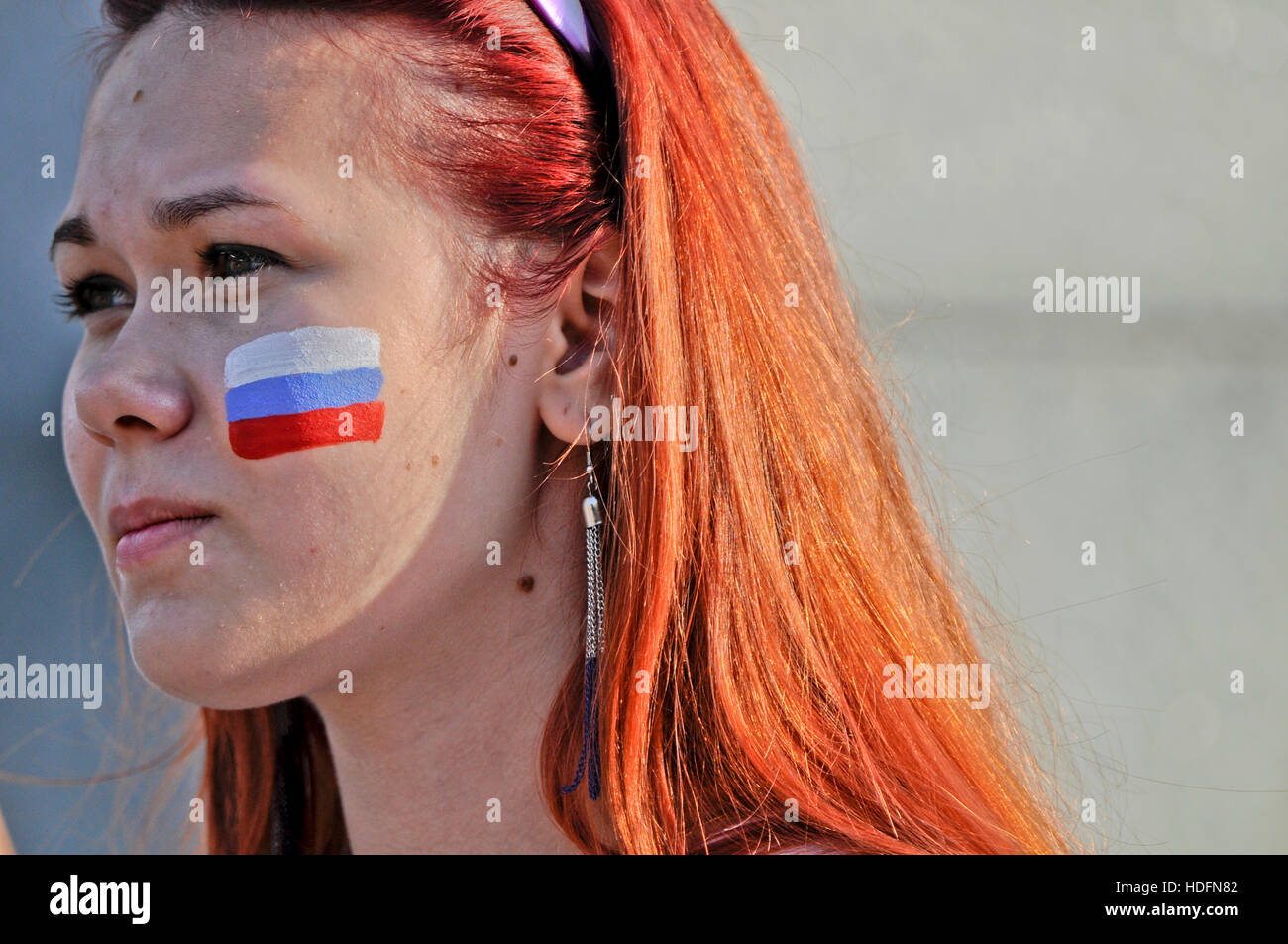 Russian sports fan (woman) with her face painted with the Russian flag Stock Photo
