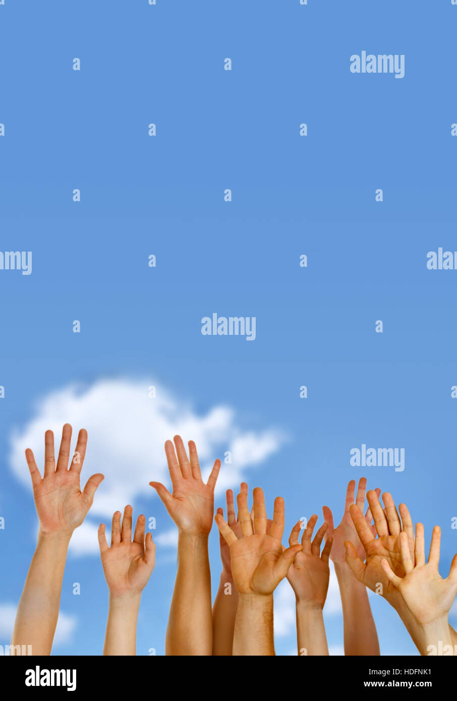 Hands raised up in air across blue sky Stock Photo - Alamy