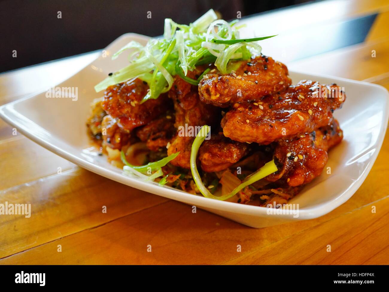 Platter of Korean barbecue chicken wings with scallions Stock Photo Alamy