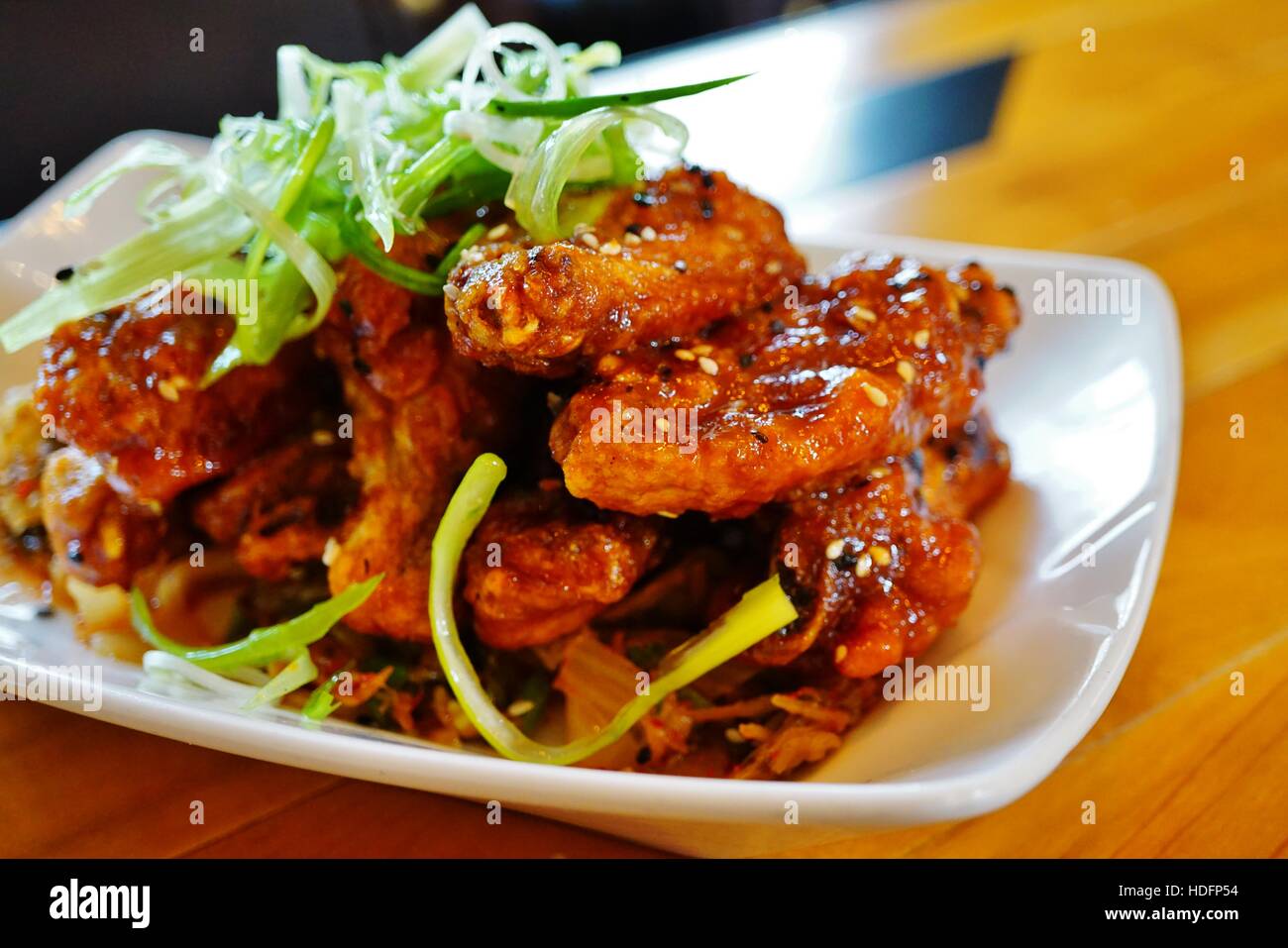 Platter of Korean barbecue chicken wings with scallions Stock Photo Alamy