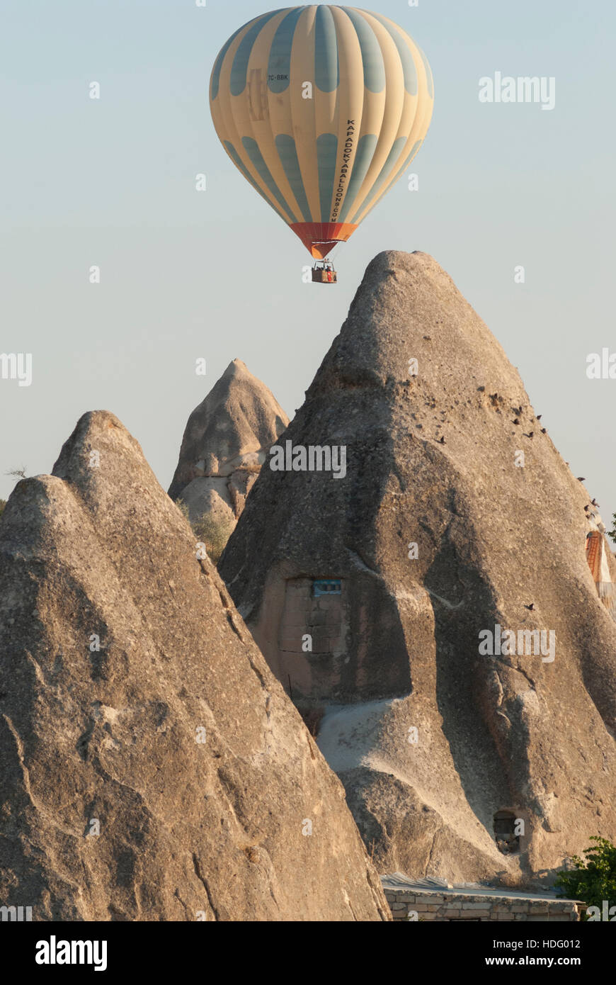 Hot air balloon floats among Fairy Chimneys in Cappadocia, Turkey. Stock Photo