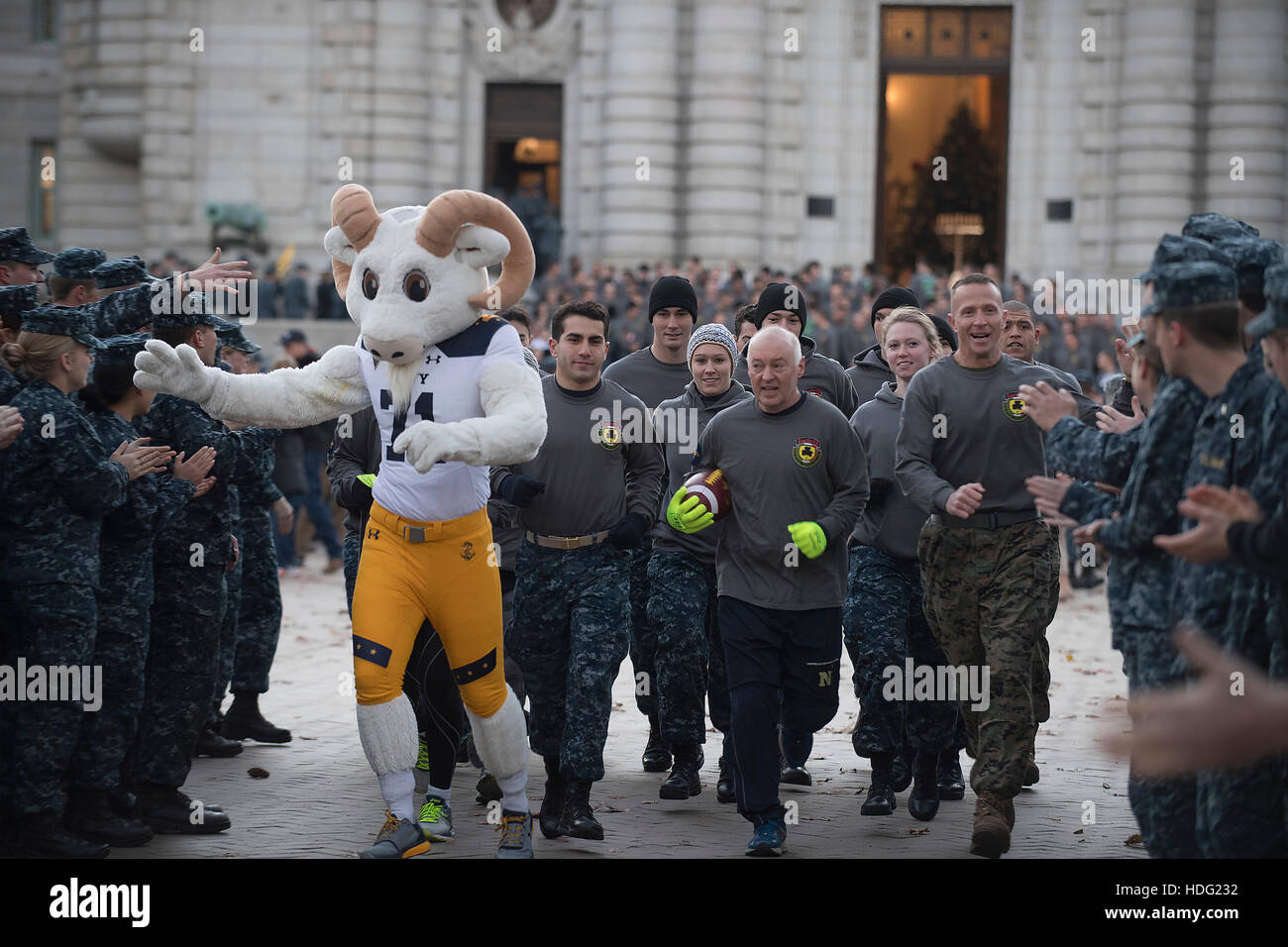 Joseph Jablonski, father of late Midshipman 1st Class Jason Jablonski, center, and USMC Col. Stephen Liszewski, right, join mascot Billy the Goat to run the Army-Navy Game ball to M&T Stadium for the 117th annual Army-Navy game December 9, 2016 in Baltimore, Maryland. Stock Photo
