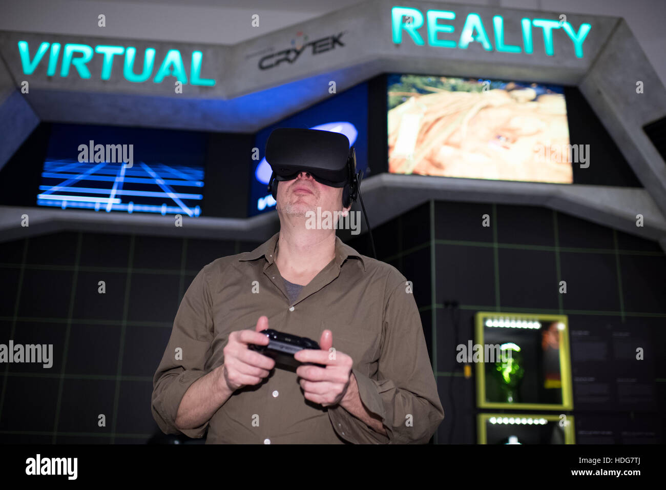 Berlin, Germany. 12th Dec, 2016. Andreas Lange, director of the Computer Game Museum in Berlin tests a virtual reality game with a pair of special glasses in the new exhibition area for Virtual Reality at the Computer Game Museum in Berlin, Germany, 12 December 2016. Photo: Bernd von Jutrczenka/dpa/Alamy Live News Stock Photo