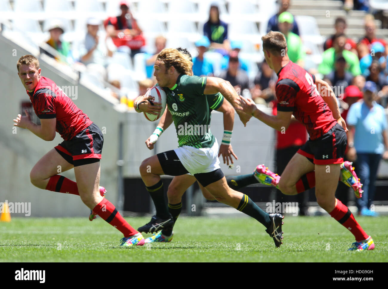 The SA Rugby Springbok Sevens players in action during the 2016 HSBC Sevens tournament at the Cape Town Stadium in Green Point Point, Cape Town. Stock Photo