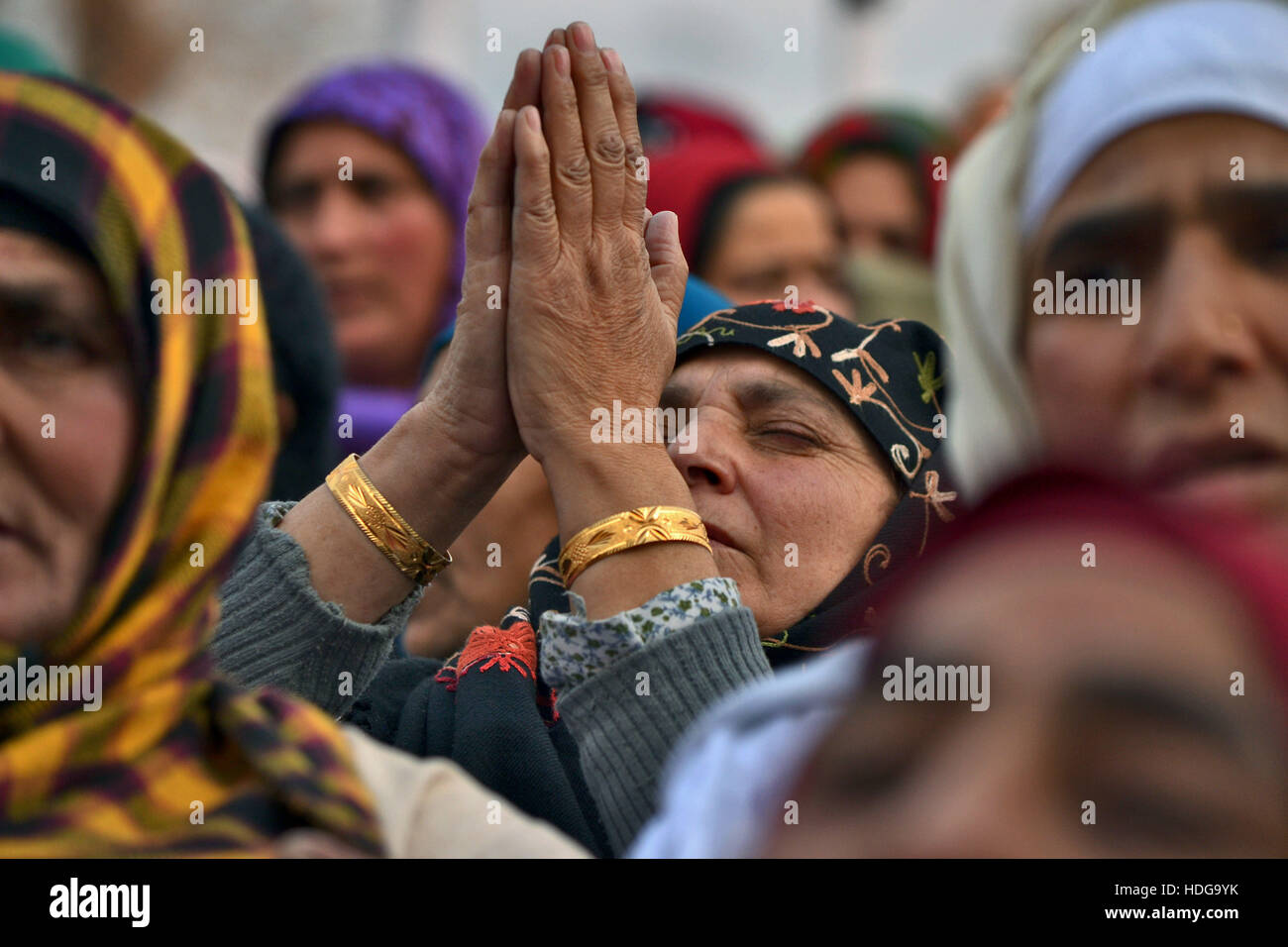 Kashmir. 12th Dec, 2016. Kashmiri Muslim women react as an unseen priest displays a holy relic believed to be the hair from the beard of Prophet Mohammed at the Hazratbal shrine on the occasion of a festival that commemorates the birthday of Prophet Muhammad in Srinagar, Indian-administered Kashmir. Credit:  Saqib Majeed/Alamy Live News Stock Photo