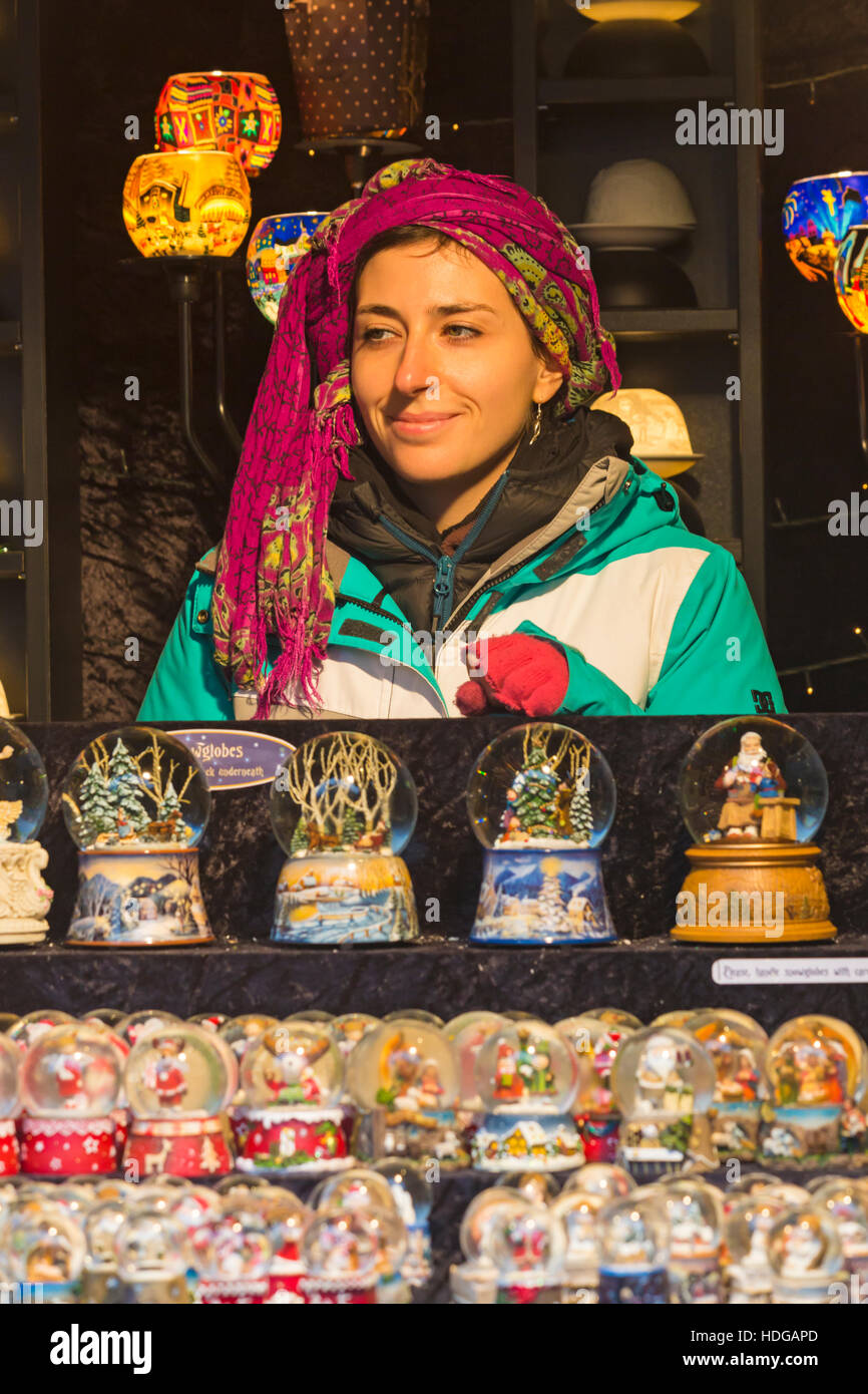 Winchester, Hampshire, England UK 12 December 2016. Market stall holder with Christmas snow globes for sale at Winchester Christmas Market. Credit:  Carolyn Jenkins/Alamy Live News Stock Photo