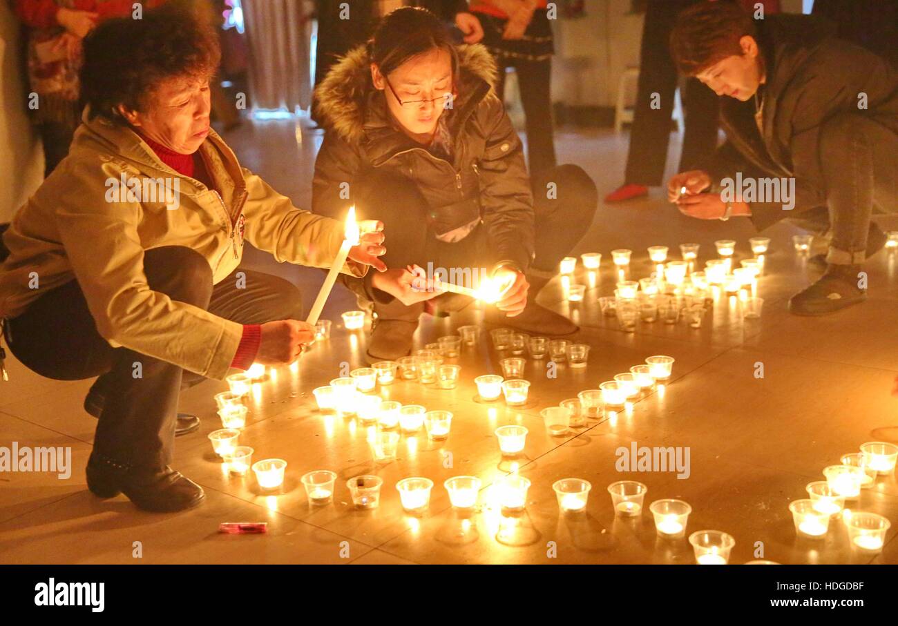 Qinhuangdao, China. 12th Dec, 2016. Qinhuangdao, CHINA-December 12 2016: (EDITORIAL USE ONLY. CHINA OUT) .People light candles to mourn victims of the Nanjing Massacre in Qinhuangdao, north China's Hebei Province, December 12th, 2016. Nanking Massacre or Nanjing Massacre, also known as the Rape of Nanking or Rape of Nanjing, was an episode of mass murder and mass rape committed by Japanese troops against the residents of Nanjing. The massacre occurred over a period of six weeks starting on December 13, 1937, the day that the Japanese captured Nanjing. Credit:  ZUMA Press, Inc./Alamy Live News Stock Photo