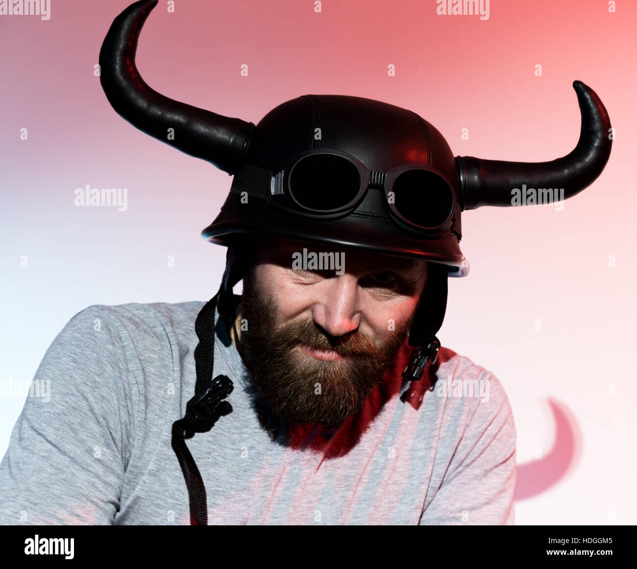 Alamy Rocker silhouette Rocker man in a horned helmet posing on red background Stock ...