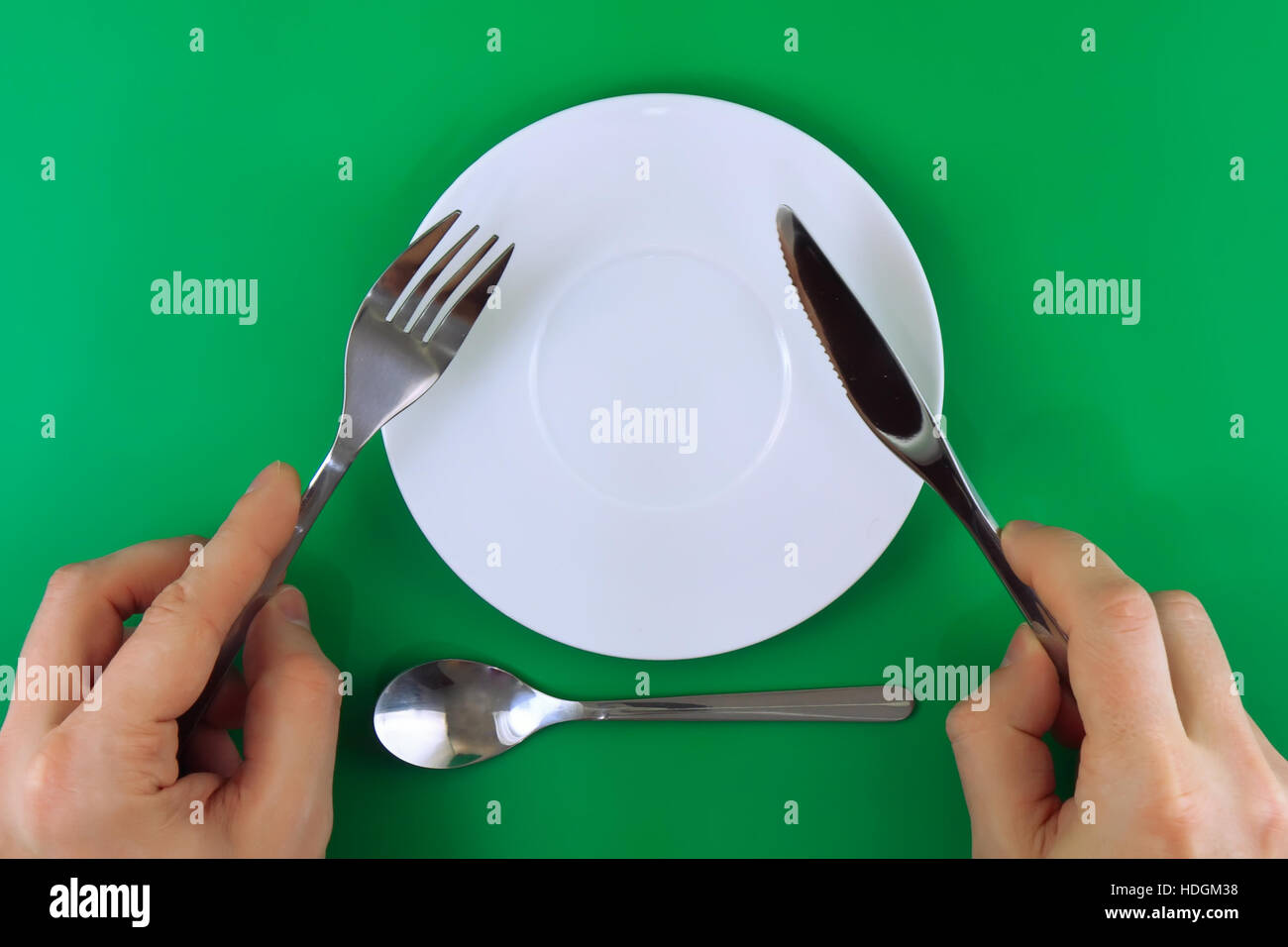 Table servingknife, fork in hands on colour background Stock Photo Alamy