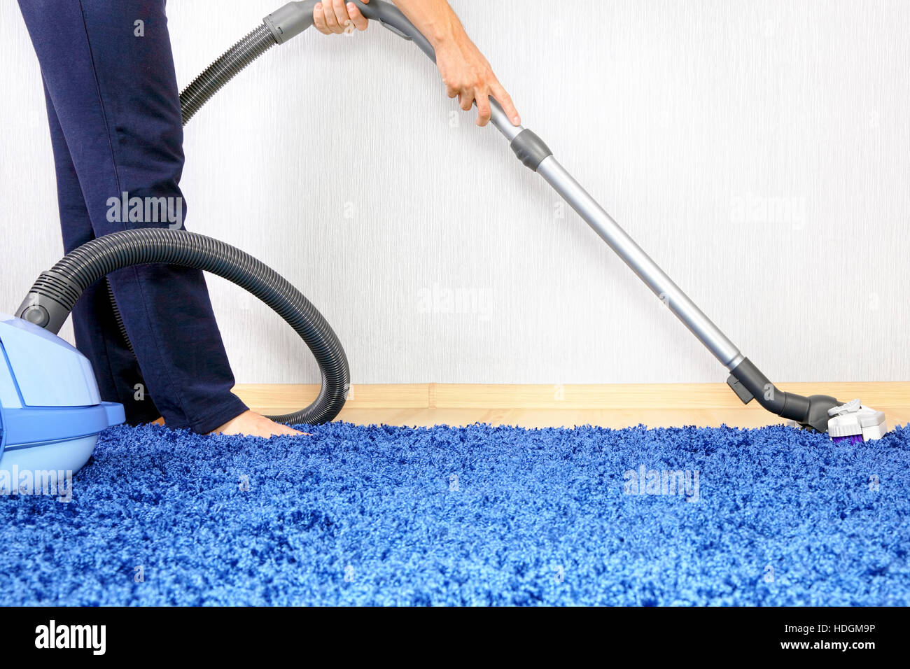 Powelful vacuum cleaner in actiona men cleaner a carpet Stock Photo