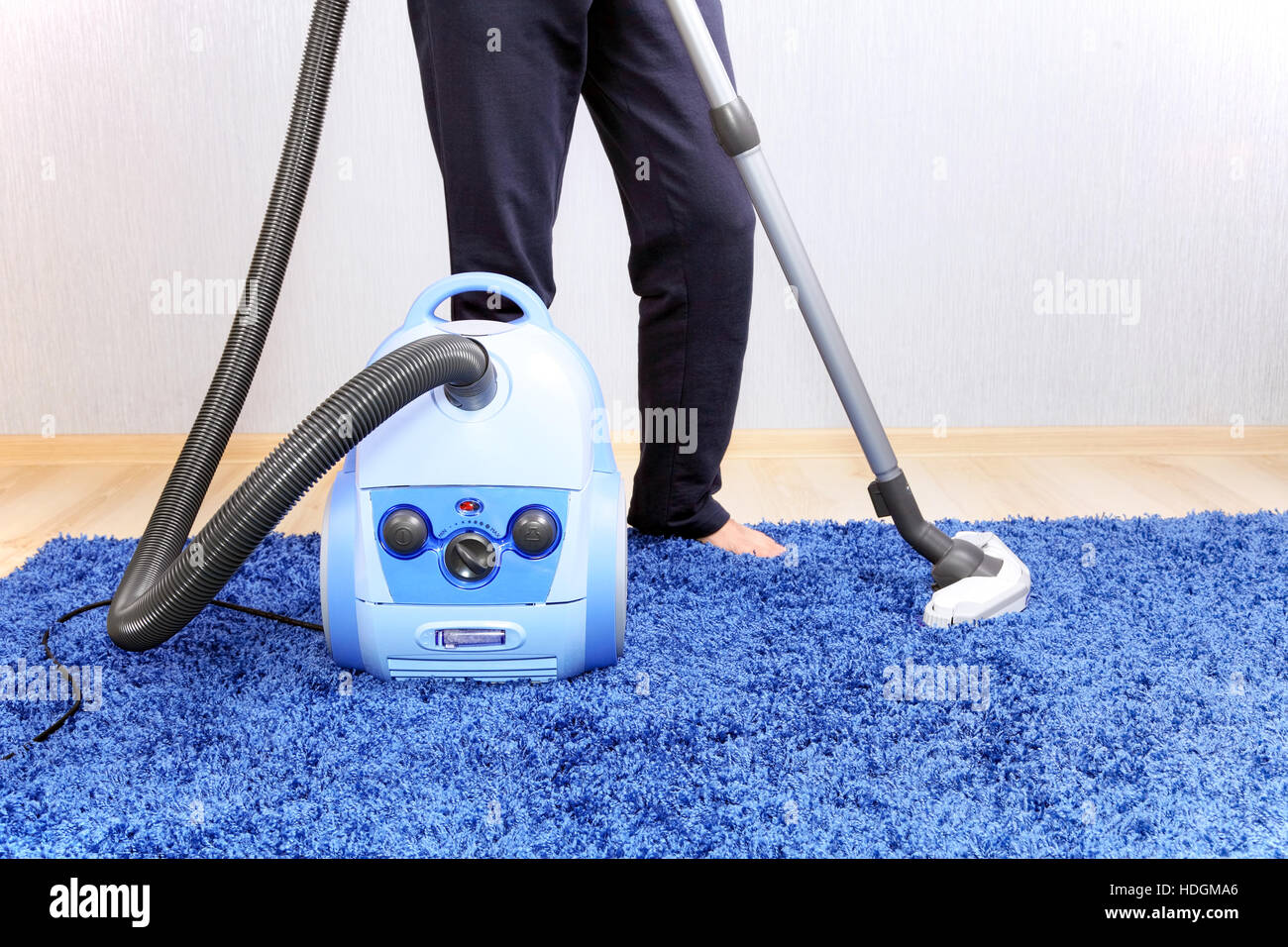 Powelful vacuum cleaner in actiona men cleaner a carpet Stock Photo