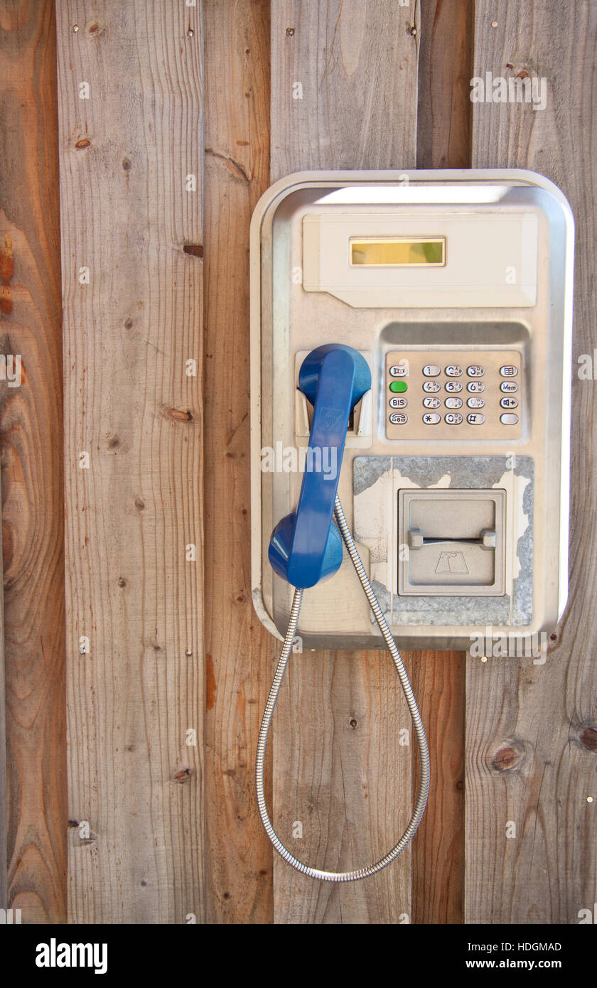 Vintage telephone hanging on wooden wall for background use Stock Photo