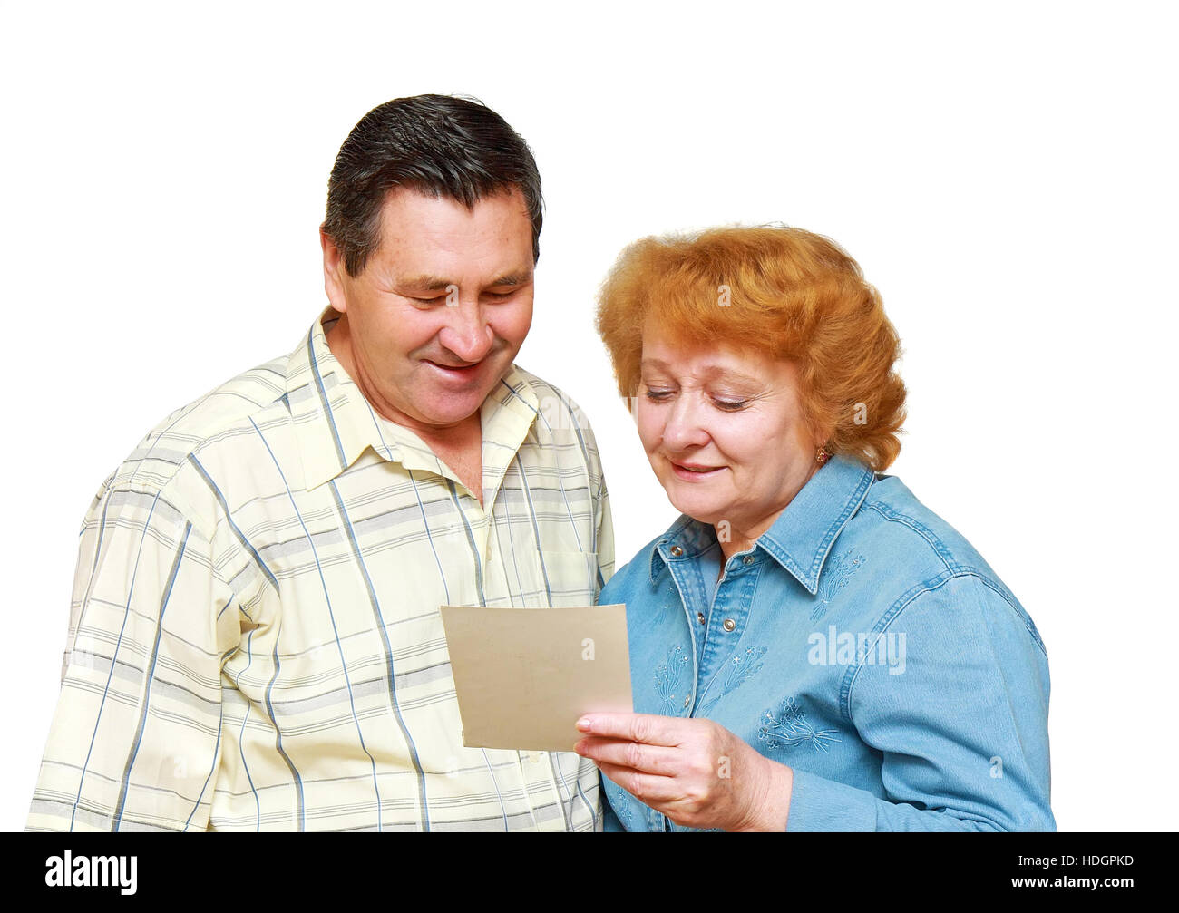 Two pensioners, couple, look on family picture with gladness. Isolated. Stock Photo