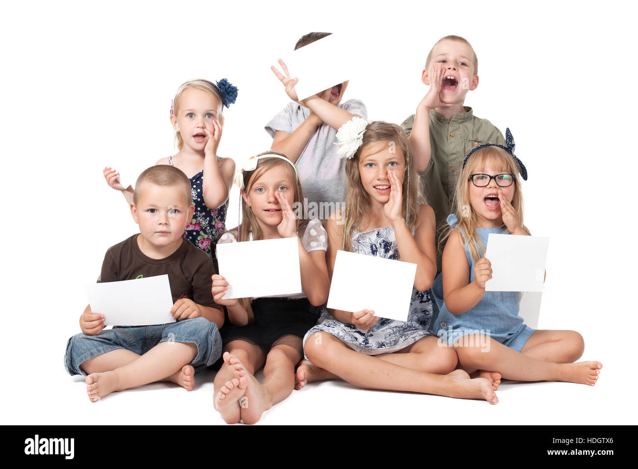 a group of children holding white card Stock Photo - Alamy