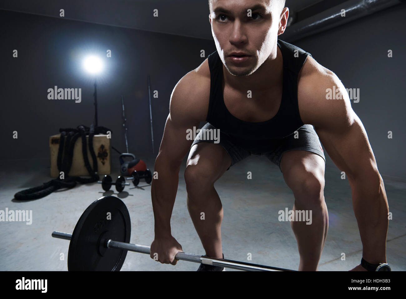 Front view of man lifting some weights Stock Photo