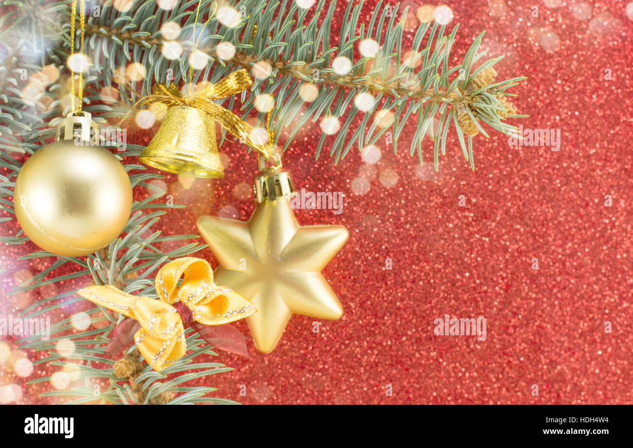 Christmas decorations and fir tree against red shiny background Stock Photo