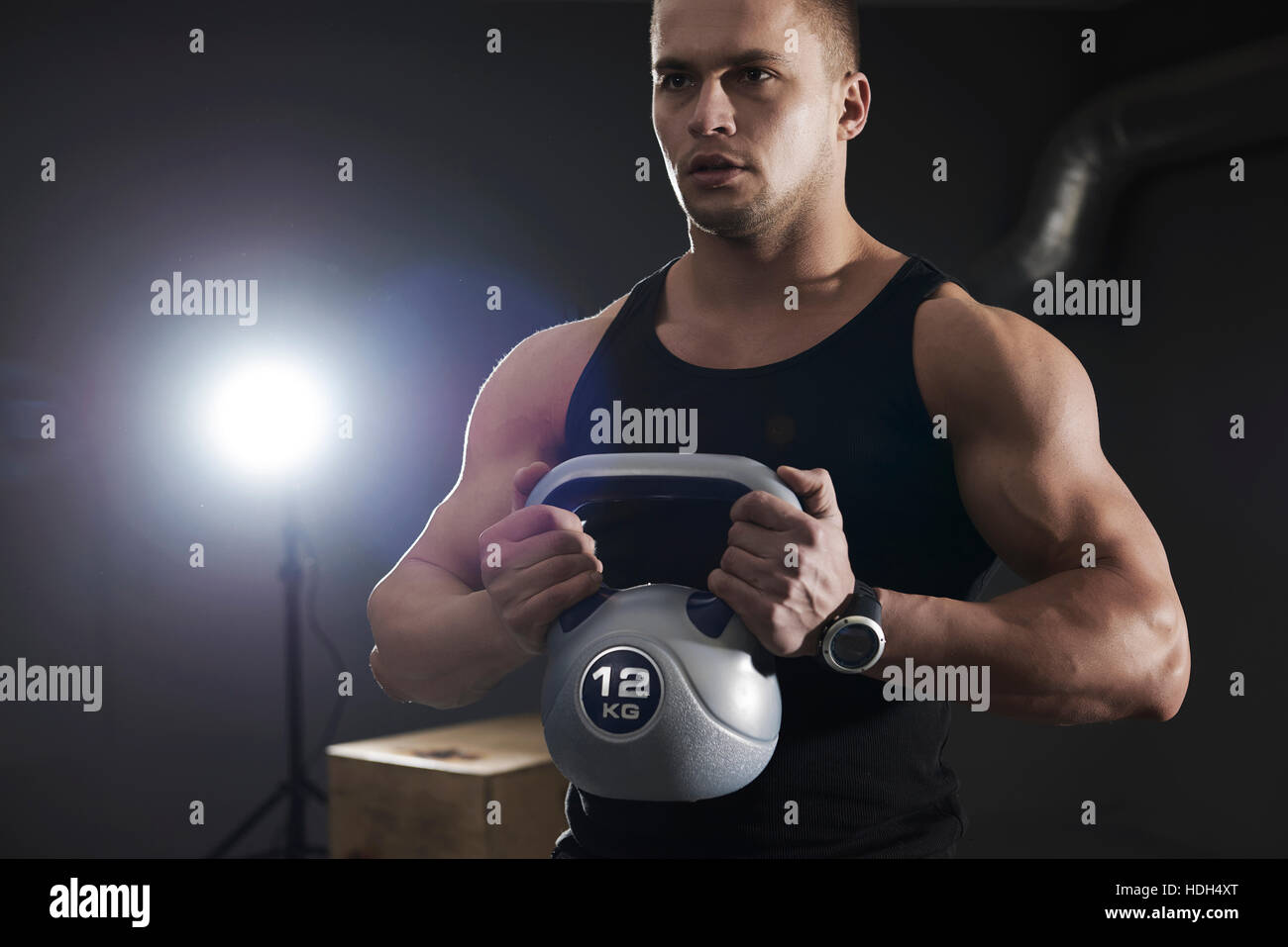Well built man lifting kettlebell Stock Photo Alamy