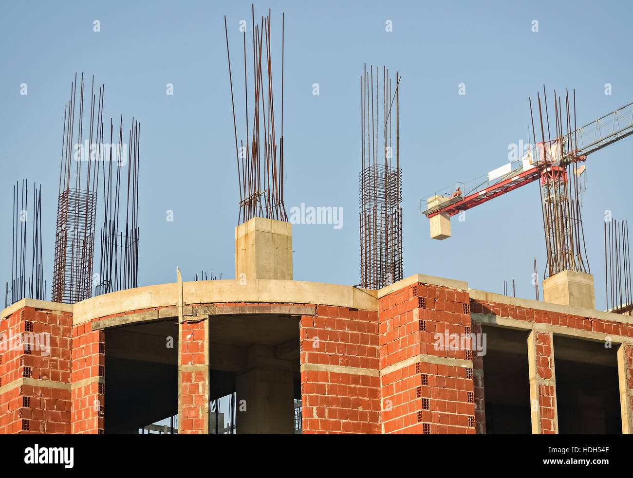 Reinforced concrete pillars and building under construction Stock Photo