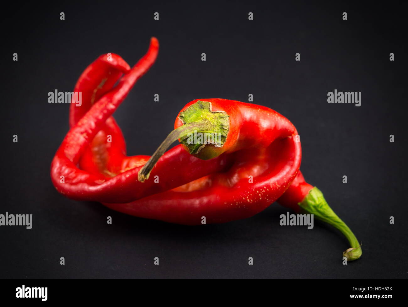 Red peppers on dark background with vignette Stock Photo