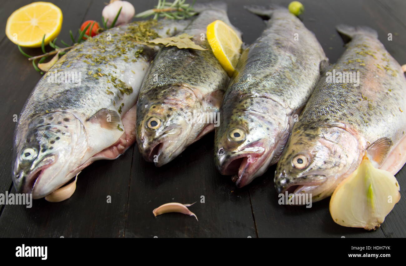raw seasoned trout on a wooden table Stock Photo