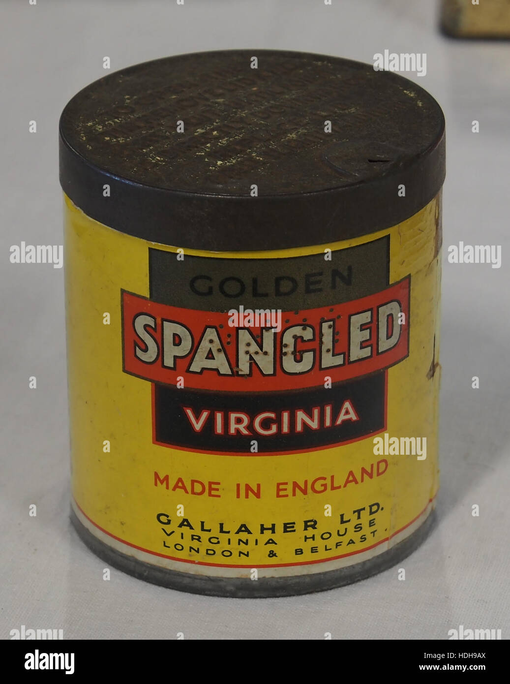 This vintage image shows a spangled cigarette tin, used for storing  cigarettes or biscuits. The design highlights the decorative nature of  packaging from the early 20th century, showcasing historical advertising  trends Stock