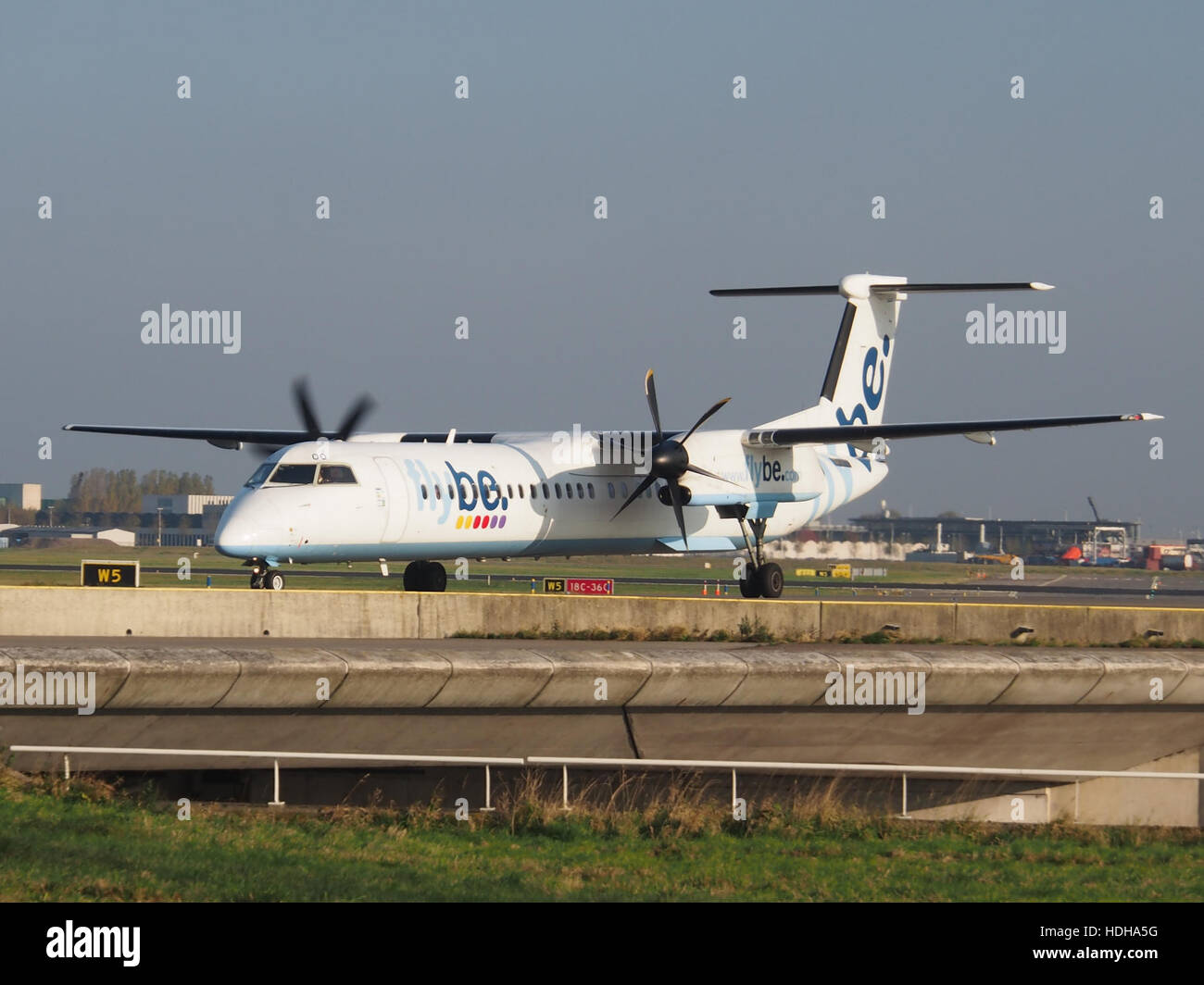 G-ECOO - Bombardier Dash 8 Q400 at Schiphol taxiing towards runway 36L pic1 Stock Photo