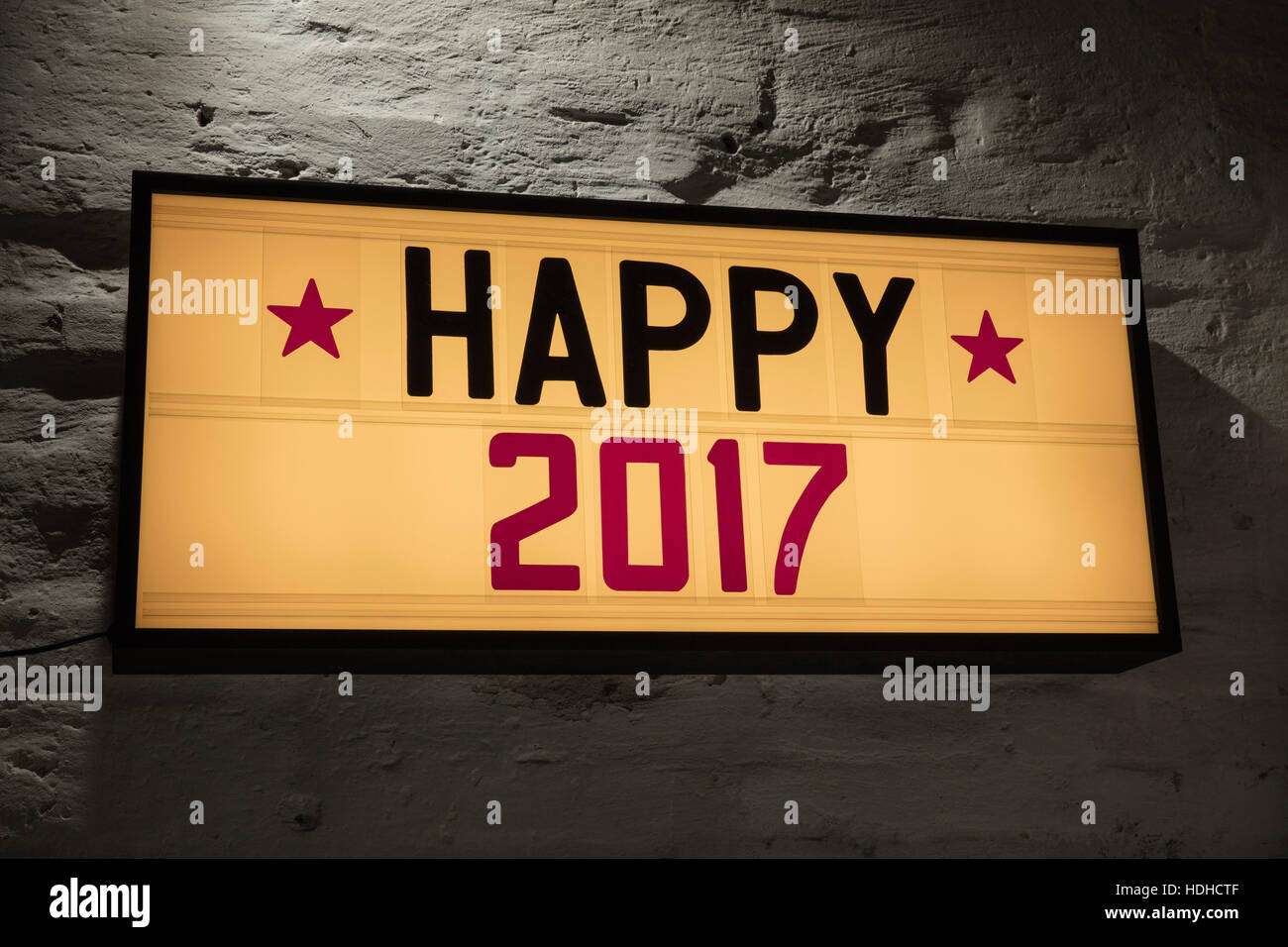 Close-up of Happy 2017 signboard against gray wall Stock Photo