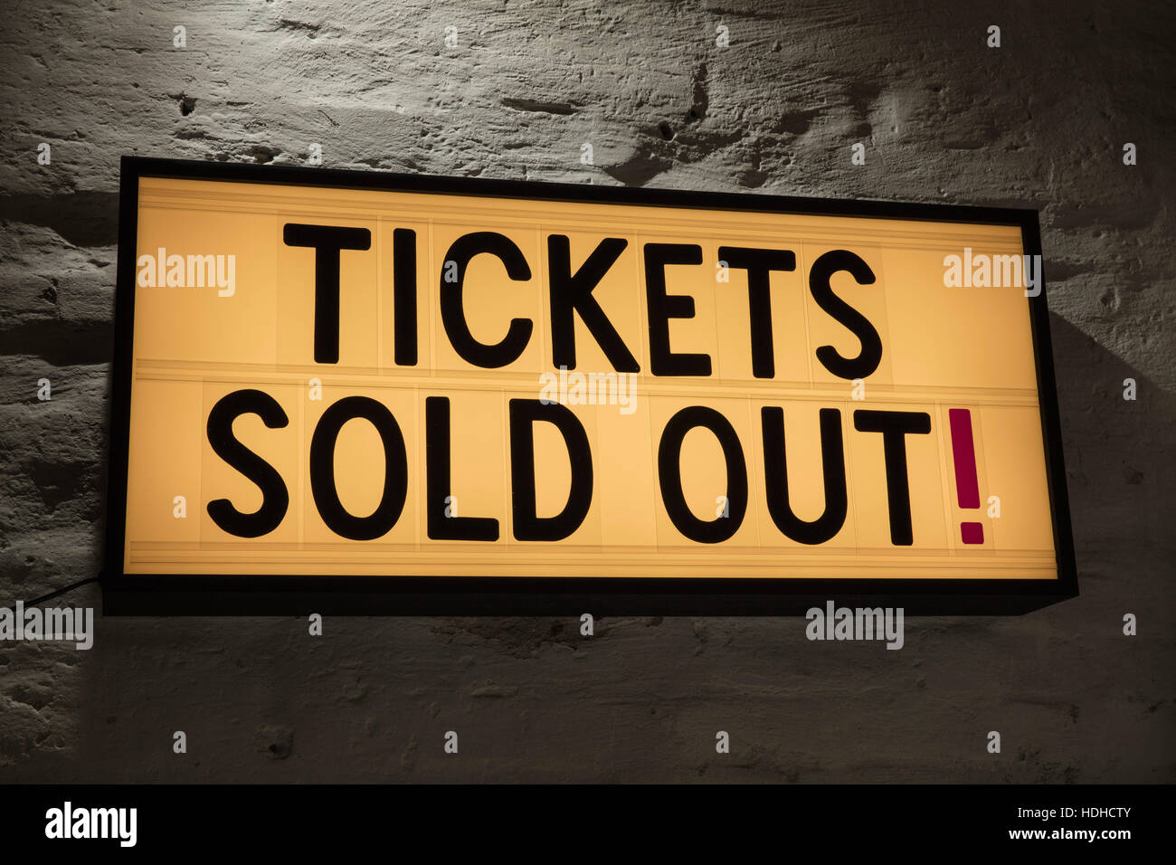 Close-up of Tickets Sold Out signboard against gray wall Stock Photo