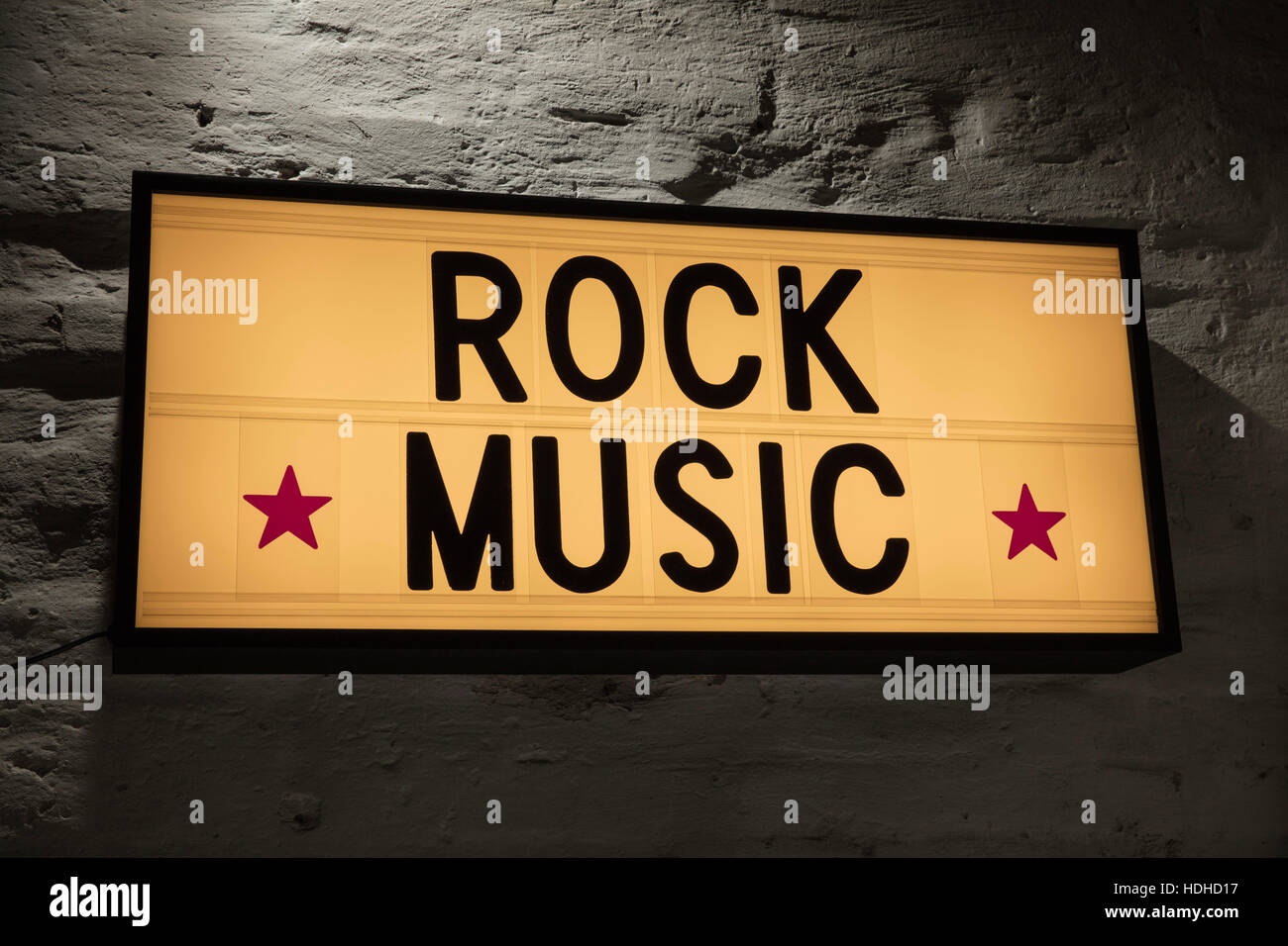 Close-up of Rock Music signboard against gray wall Stock Photo