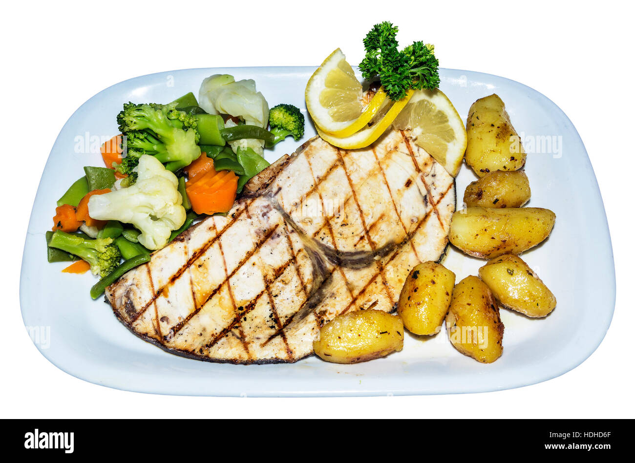 Swordfish steak local caught fish on white plate with vegetables, Algarve, Portugal Stock Photo