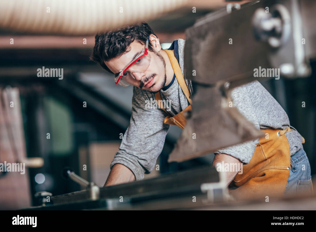 Carpenter using table saw at workshop Stock Photo