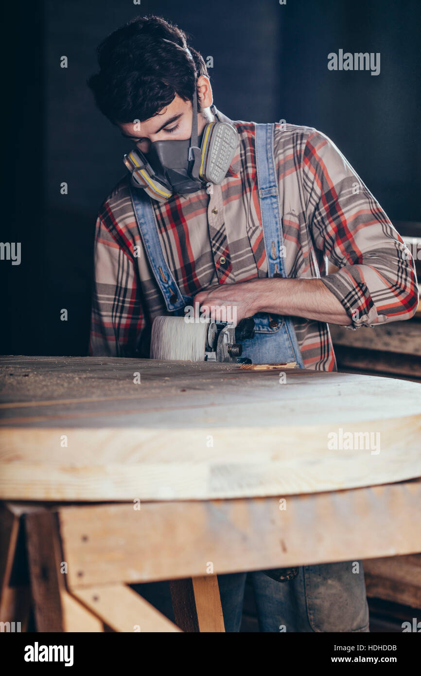 Man using electric sander on wood at Stock Photo Alamy