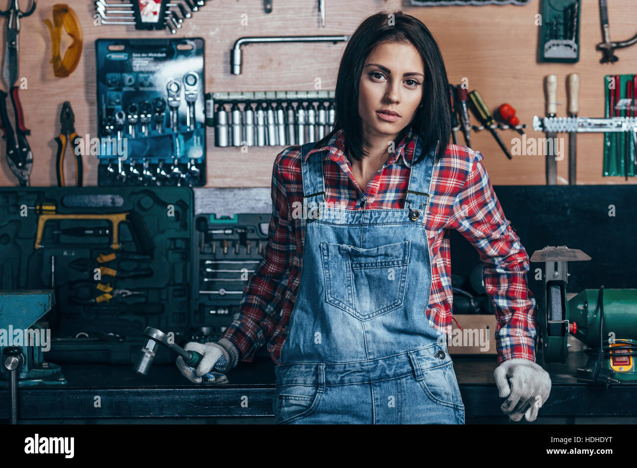 Portrait of female mechanic standing at workshop Stock Photo