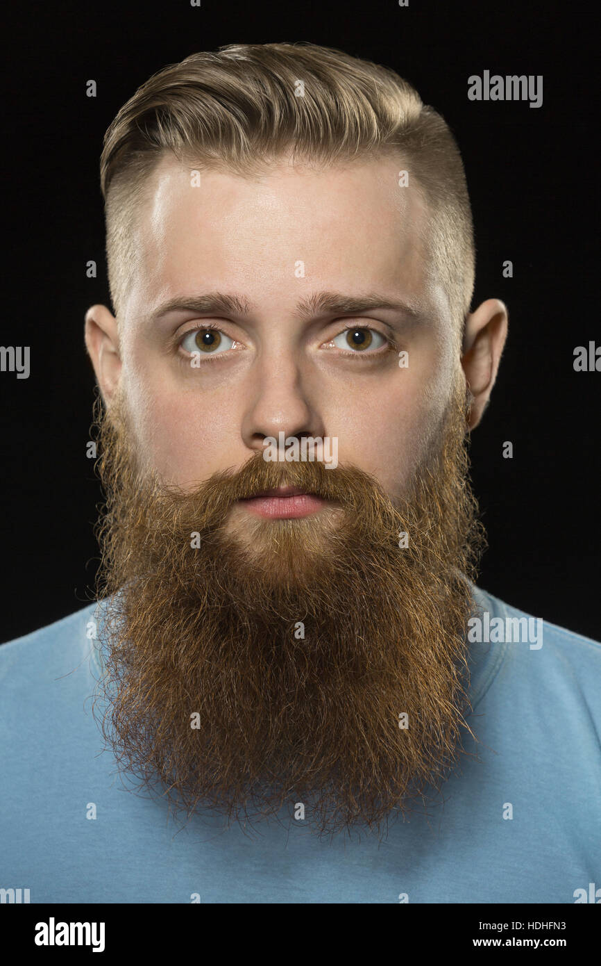 Close-up portrait of bearded man against black background Stock Photo