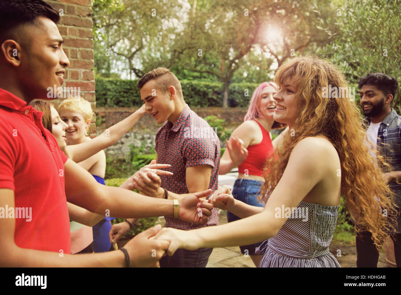 Cheerful friends dancing at yard during party Stock Photo