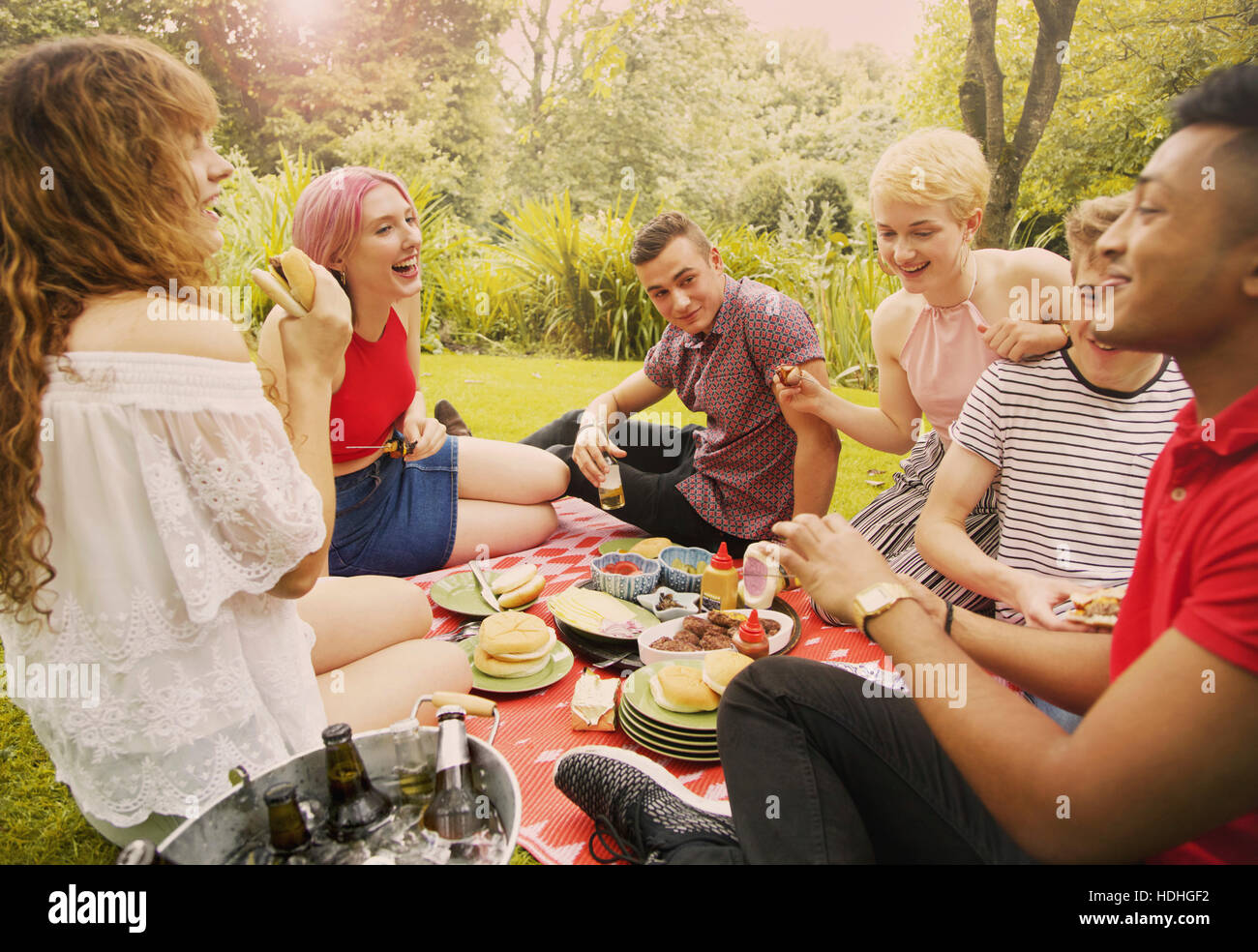 Cheerful friends having food during party at yard Stock Photo