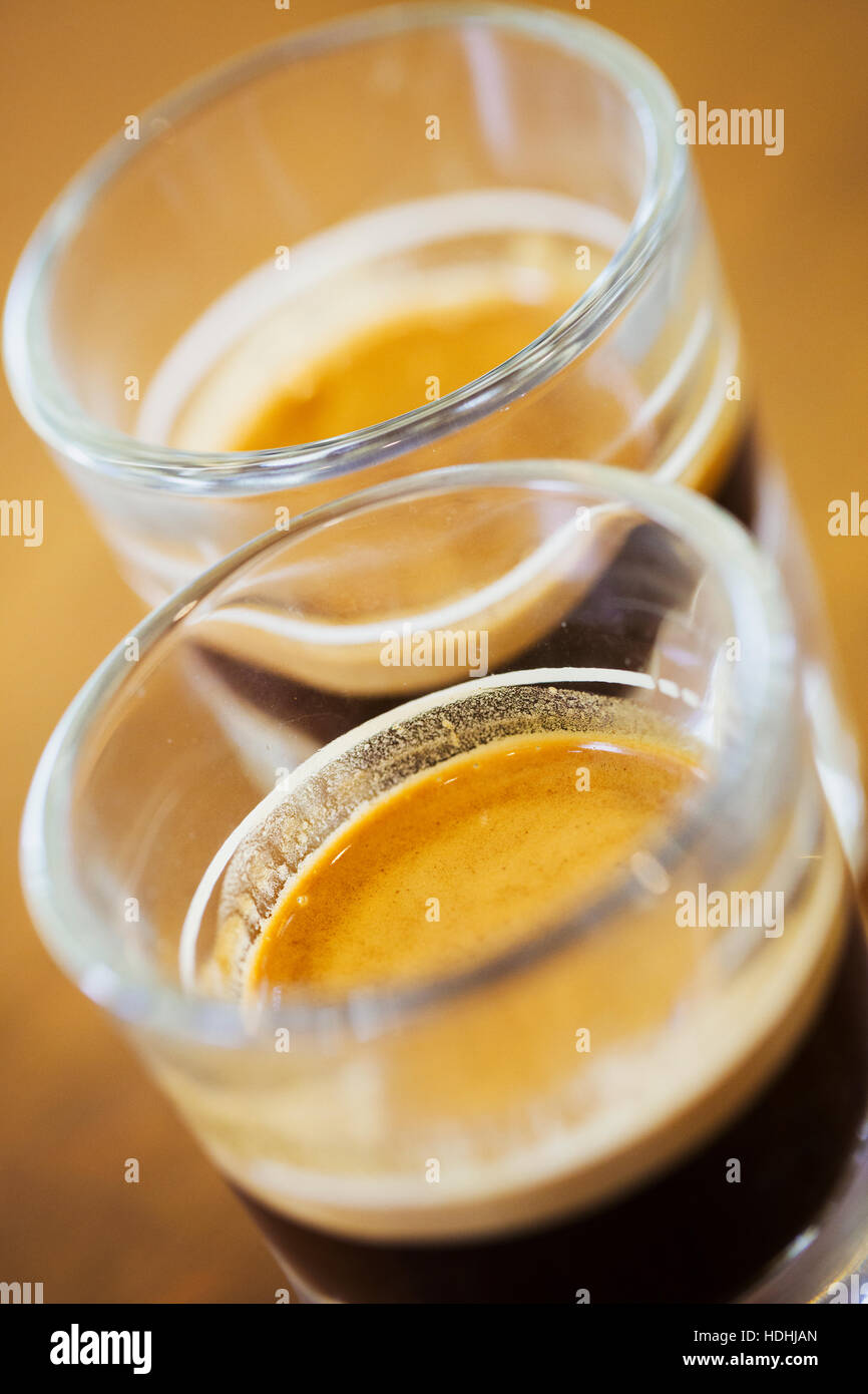 Close-up of espresso machine and shot glasses during a pour Stock Photo -  Alamy