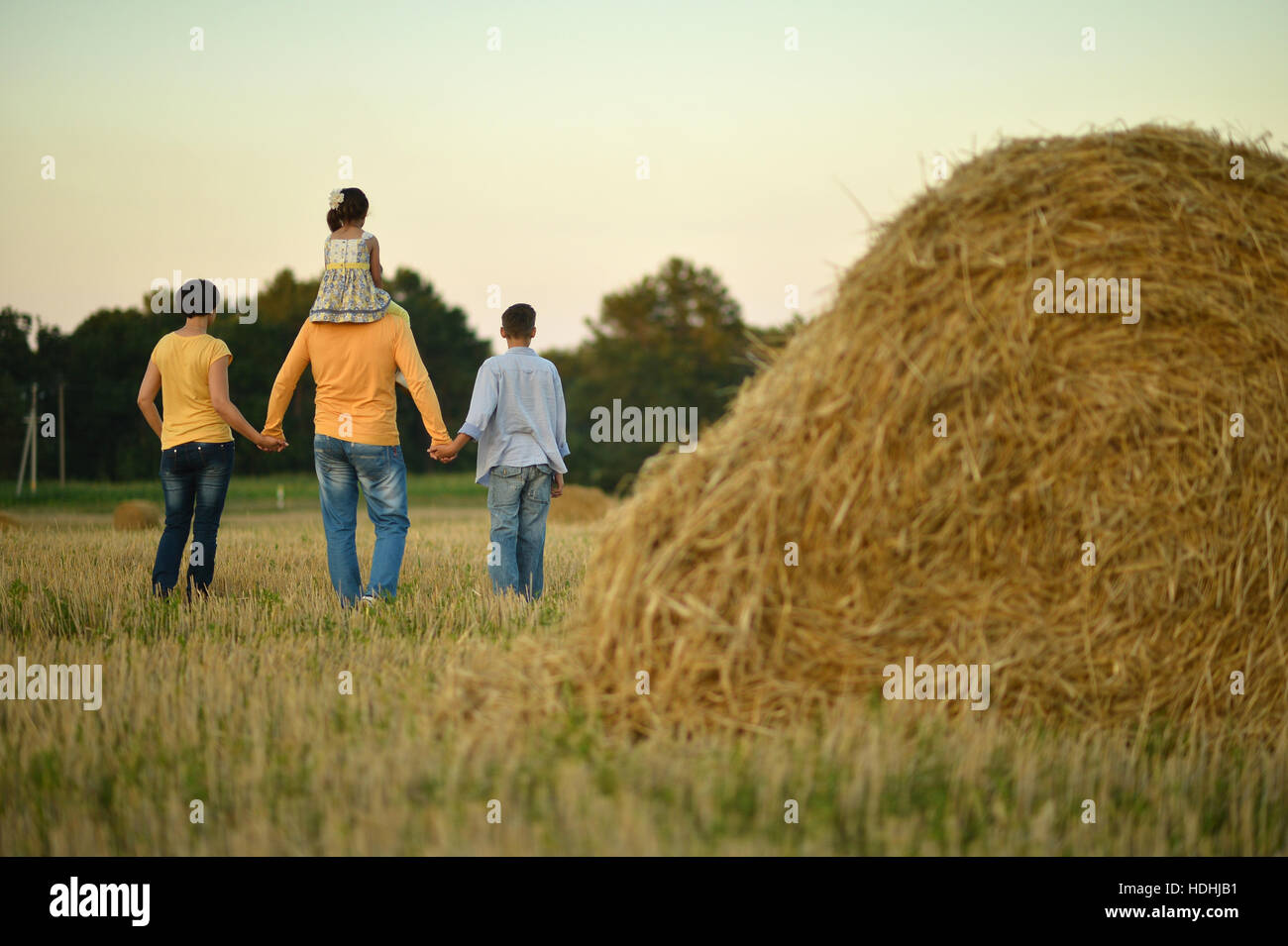 happy family at field Stock Photo - Alamy