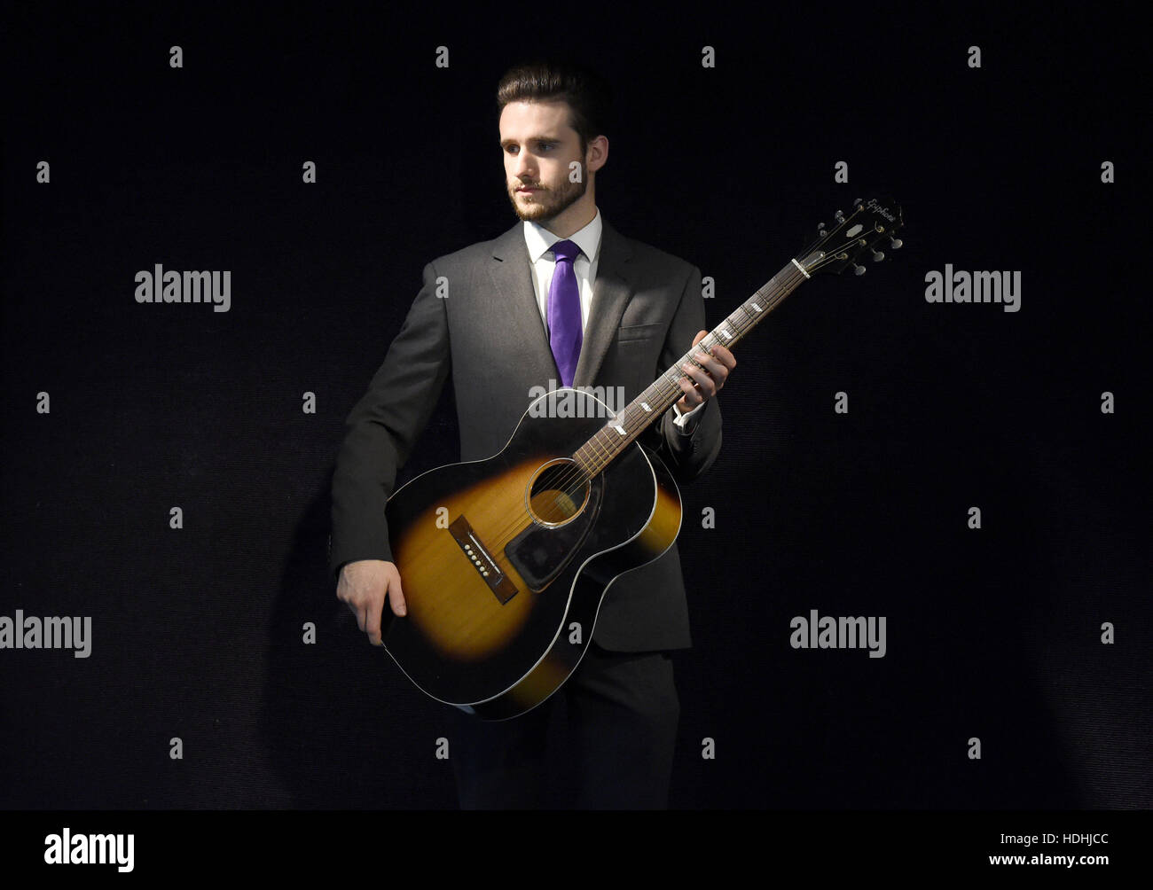 A staff member holds a guitar once owned by Jimi Hendrix on display ahead of the the Entertainment Memorabilia Sale at Bonhams in Knightsbridge, London later this week. Stock Photo