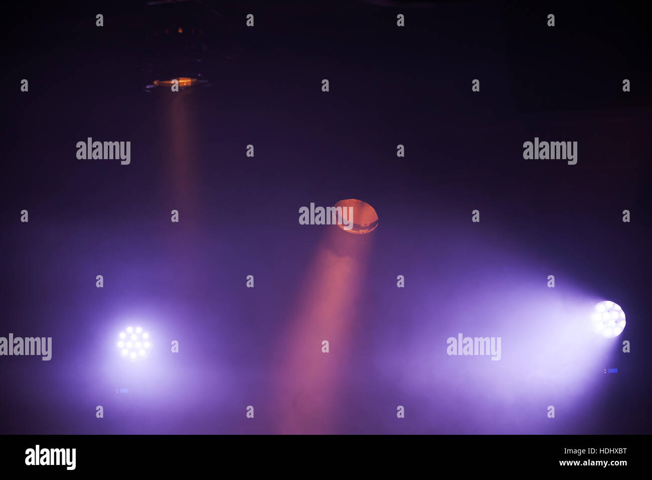 Colorful spot lights with strong beams in dark fog, stage illumination background photo Stock Photo