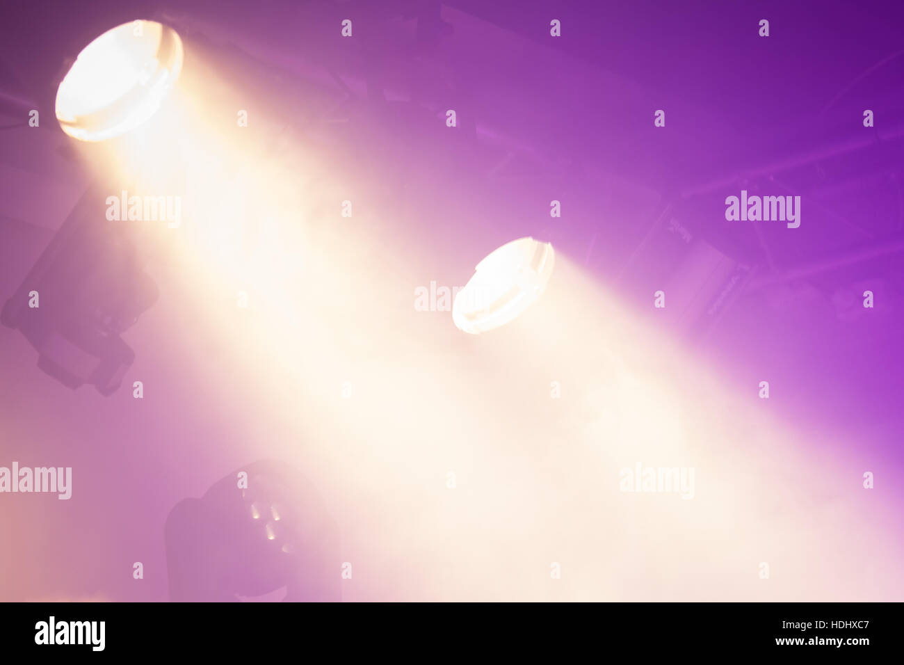 Powerful spot lights on purple background, stage illumination Stock Photo