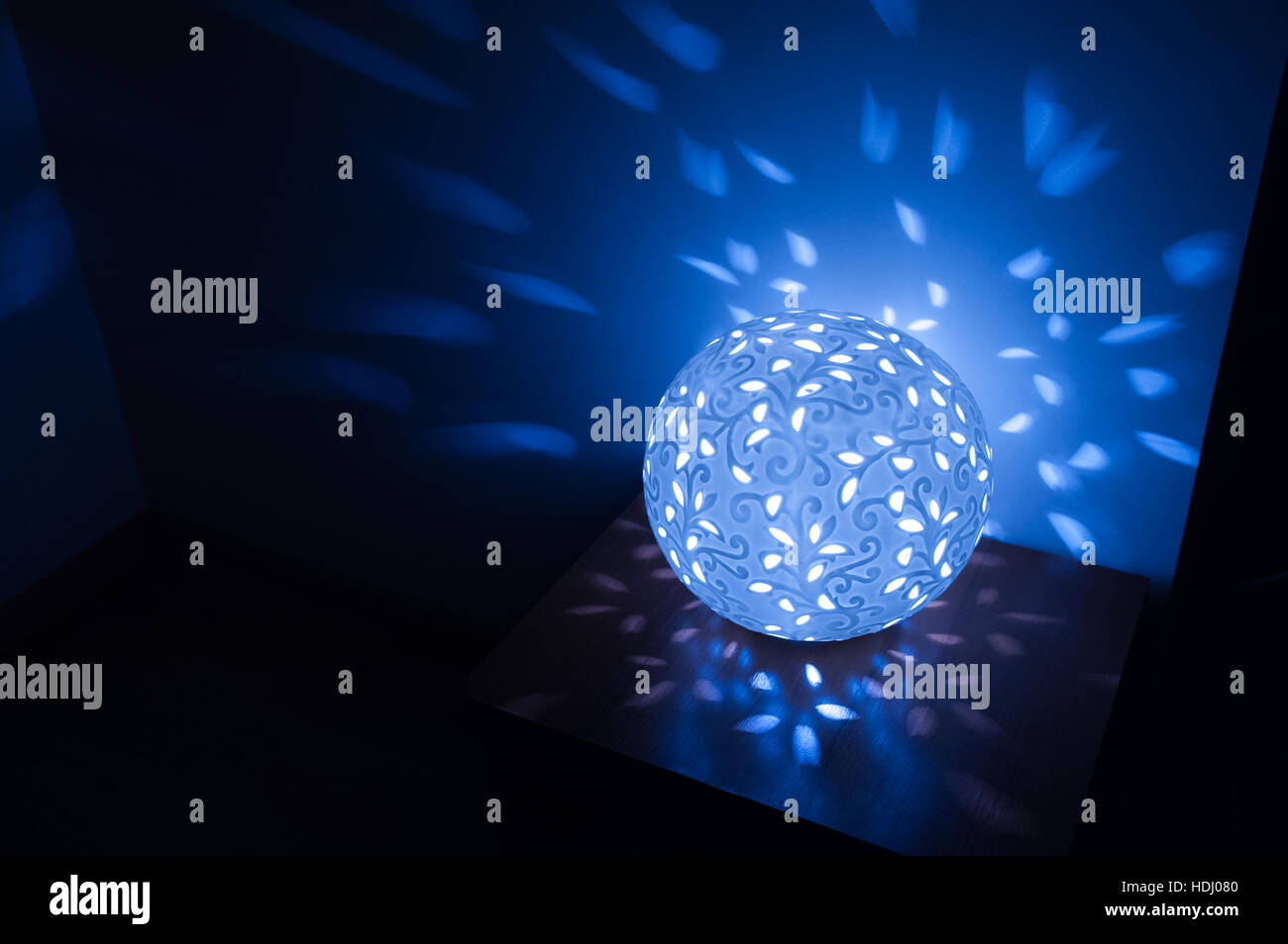 Blue table lamp included in dark room Stock Photo Alamy