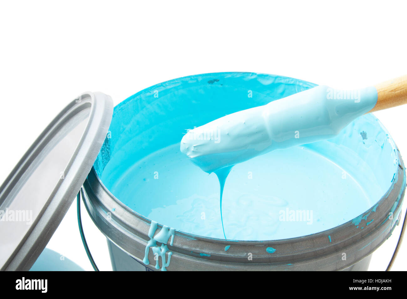 Blue paint in plastic bucket with paintbrush for background use Stock