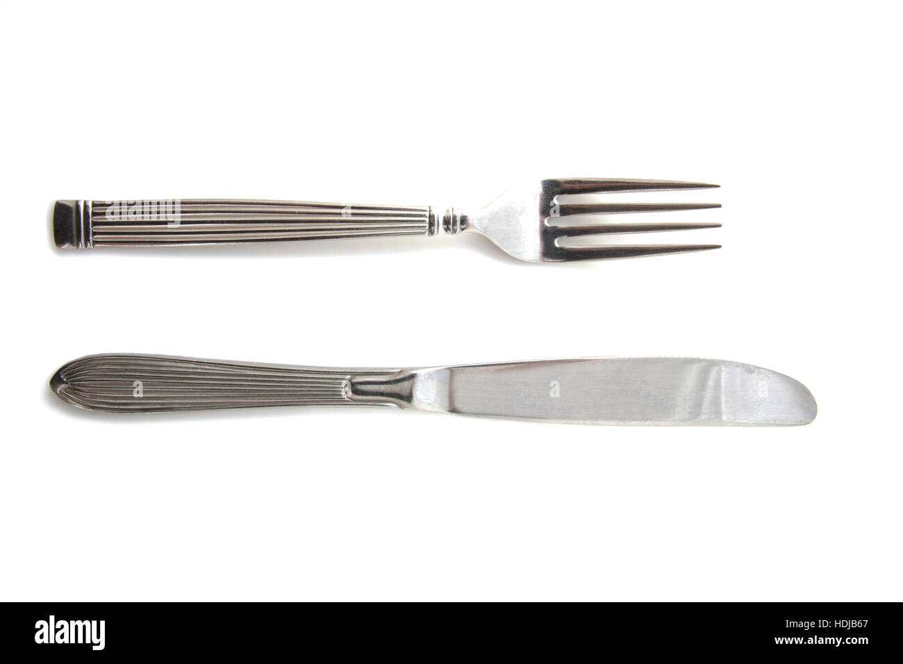 Silver knife and fork in position isolated over white Stock Photo Alamy