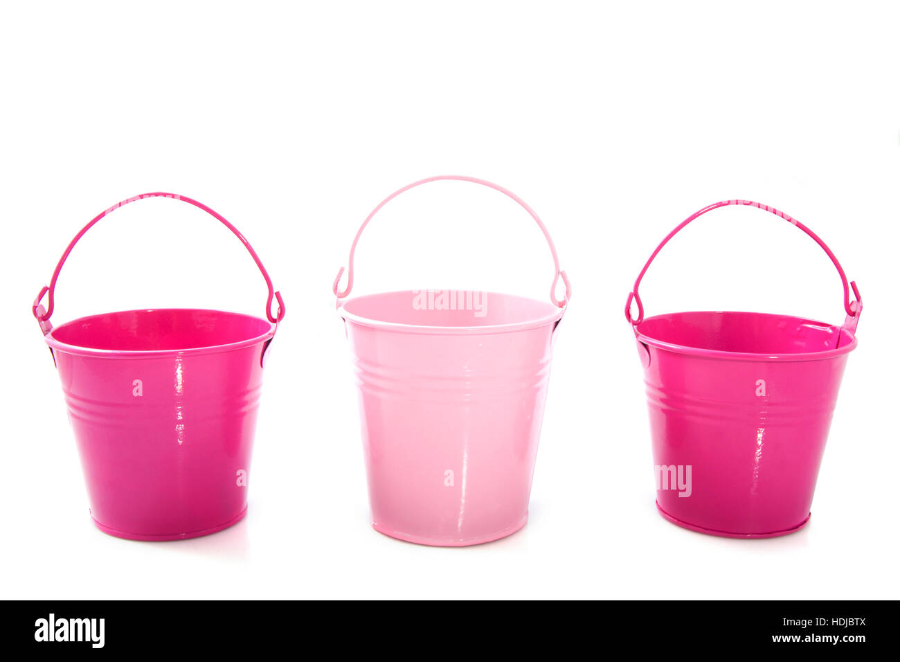 Three pink buckets in a row isoloated over white Stock Photo Alamy