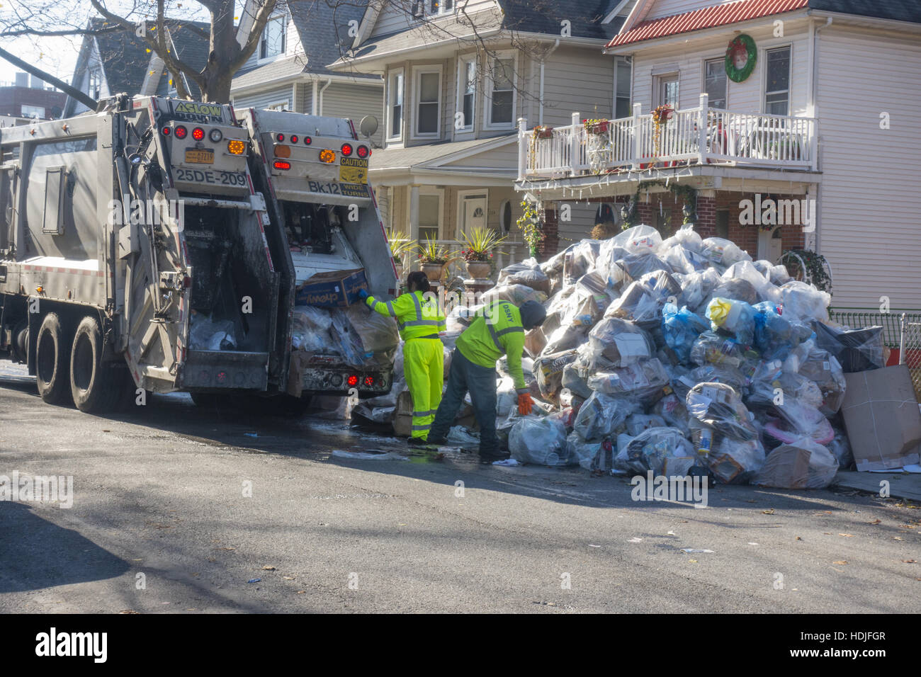 Sanitation workers pick up recyclable garbage all from one building in Brooklyn, NY Stock Photo