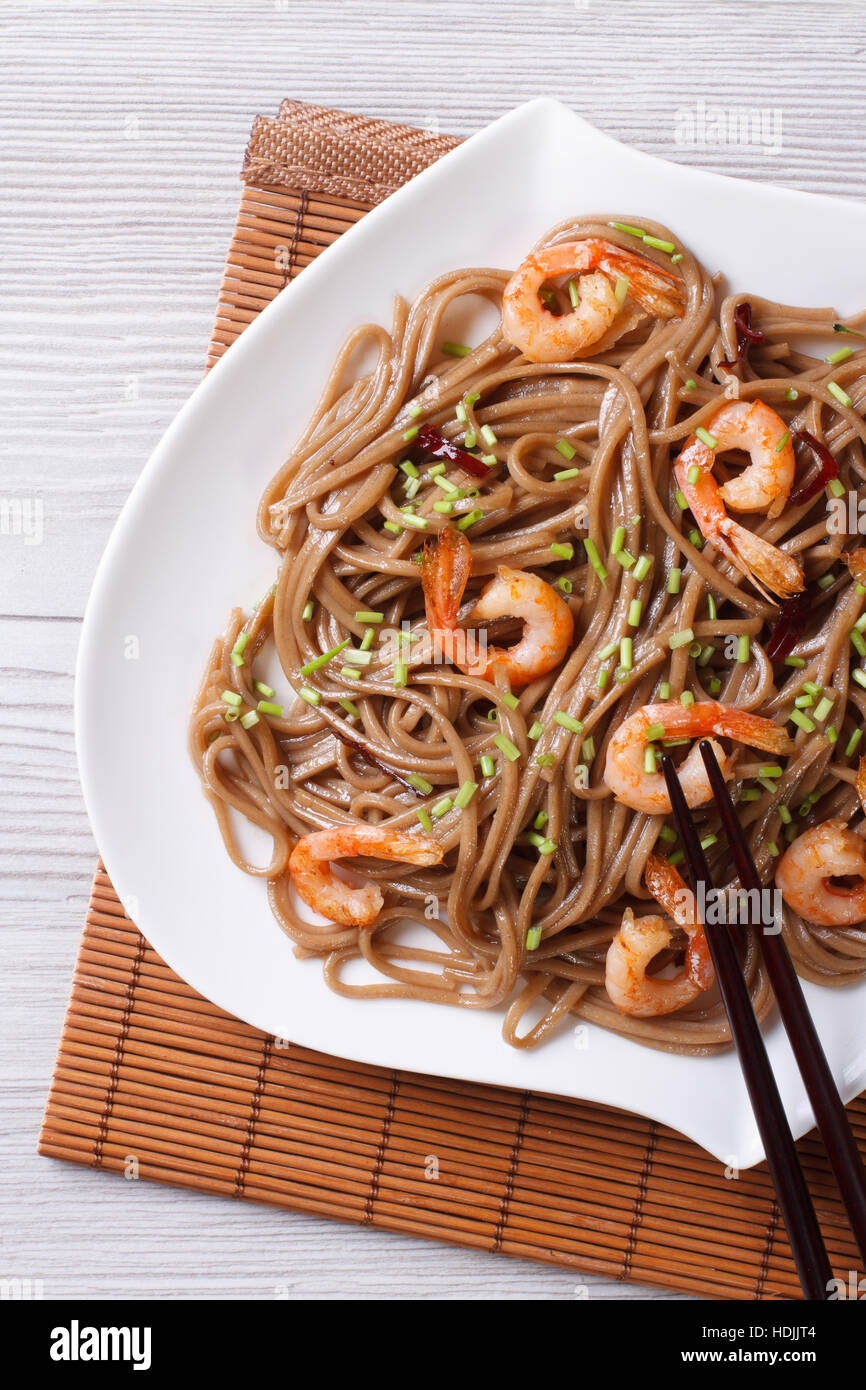 buckwheat soba noodles with shrimp on a plate closeup. vertical Stock