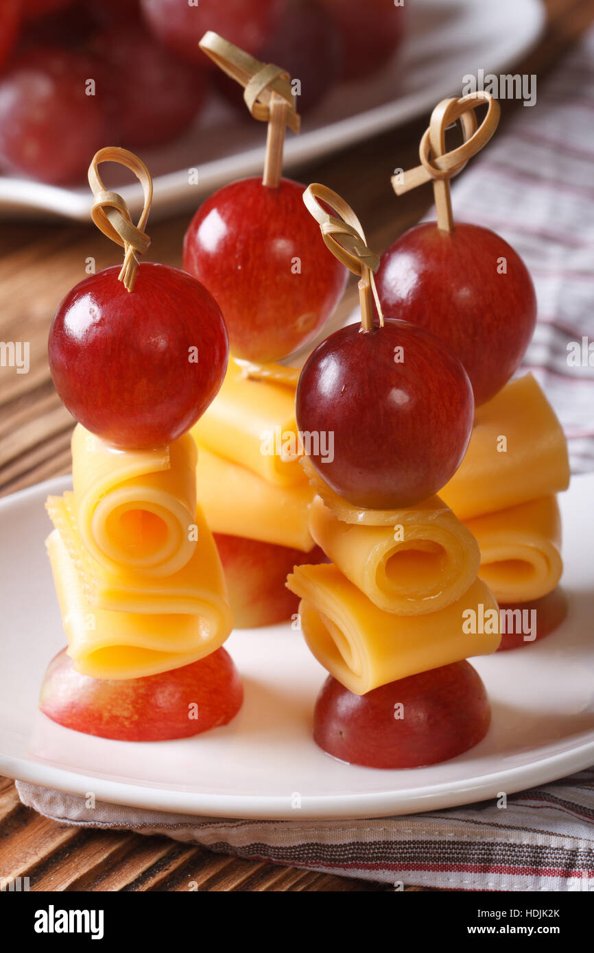 Fingerfood grapes and cheese on skewers closeup vertical Stock Photo