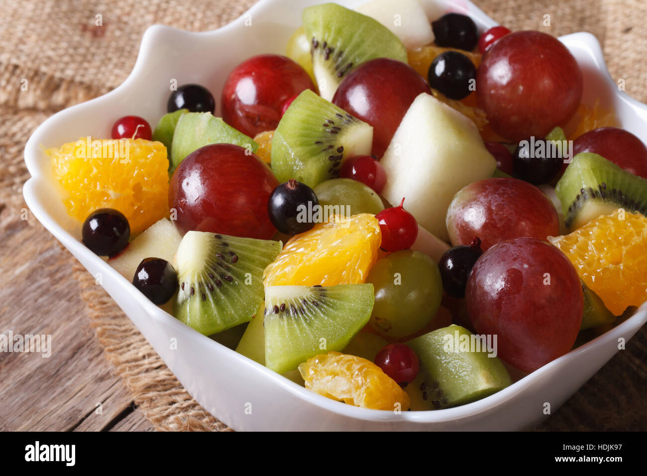 Fruit salad of oranges, kiwi, grapes and berries macro. Horizontal Stock Photo