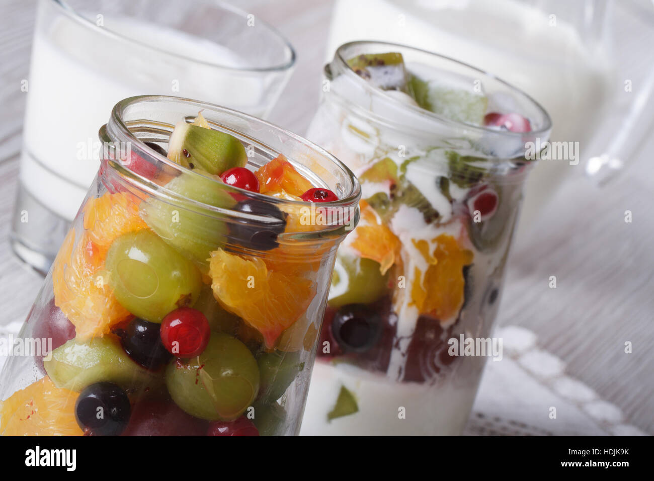 pieces of fresh fruit in a glass jar and yogurt on the table macro horizontal Stock Photo